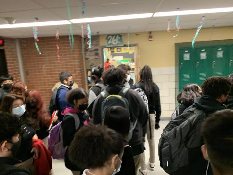 Masked students make their way through crowded halls at in-person learning resumes.