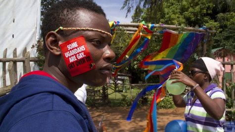 A Ugandan man with a sticker on his face takes part in the annual gay pride in Entebbe, Uganda, on August 9, 2014. |CNN